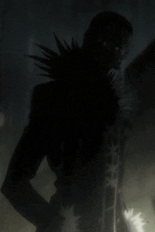 a silhouette of a person with spikes on their collar