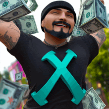 a man in a black shirt with an x on it is holding a bunch of money