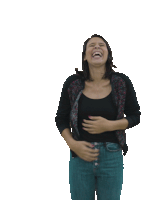 a woman is laughing while holding her belly