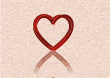 a red heart with a gold outline is on a beige background