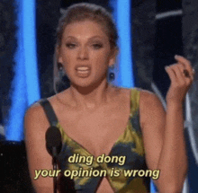 taylor swift is giving a speech at a awards show and says `` ding dong your opinion is wrong '' .