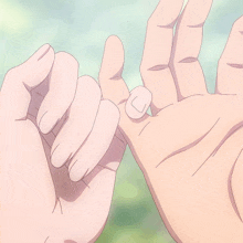 two hands are making a pinky promise with their fingers