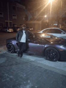 a man leans against a purple sports car