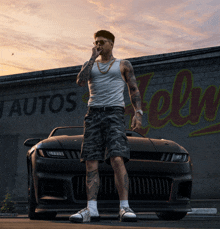 a man standing in front of a car in front of a building that says autos