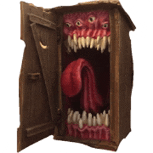 a wooden box with a monster 's mouth and teeth coming out of it