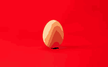 a single egg is on a red surface