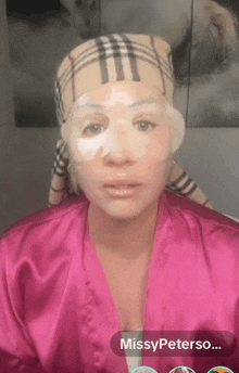 a woman in a pink robe has a mask on her face and the name missypeterso on the bottom