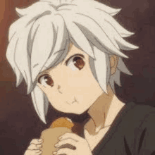 a young boy with white hair is eating a chicken nugget from a bag .