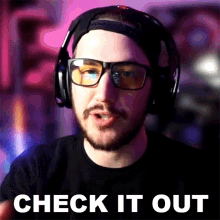 a man wearing headphones and glasses has the words check it out below him