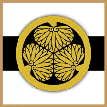 a gold and black circle with three flowers in the center