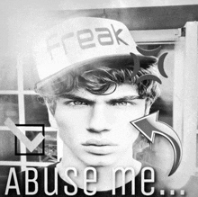 a black and white photo of a man wearing a hat that says freak