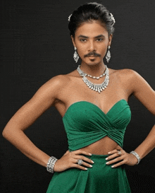 a woman wearing a green dress and jewelry has a mustache on her face