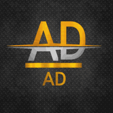 a black and gold ad logo on a metal background