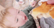 a baby is eating a slice of doughnut .