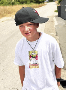 a young boy wearing a spongebob t-shirt and a hat