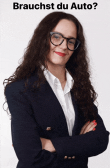 a woman wearing glasses and a suit stands with her arms crossed in front of a sign that says braucht du auto ?