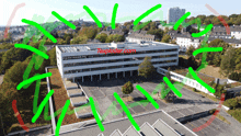 an aerial view of a building with green lines surrounding it and the words textlader.com on the top