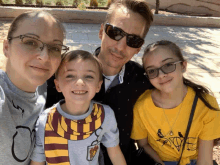 a family posing for a picture with one wearing a harry potter shirt