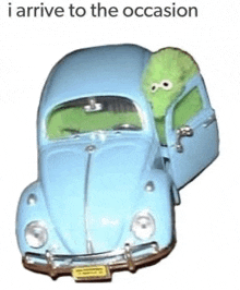 a blue toy car with a green stuffed animal in it .