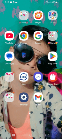 a person wearing sunglasses and a galaxy store app