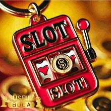 a red slot machine shaped keychain with the words slot on it