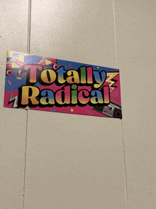 a sign that says totally radical hangs on a white wall