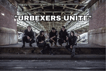 a group of people sitting under a bridge with the words " urbexers unite " on the bottom