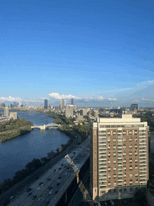 an aerial view of a city with a bridge over a river and a highway