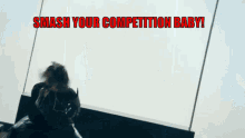 a woman is standing in front of a wall with the words " smash your competition baby " on it