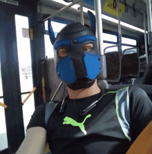 a man wearing a blue mask and a puma shirt