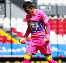 a soccer player wearing a pink jersey with the number 43