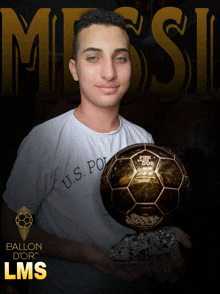 a young man is holding a golden soccer ball in front of a poster that says ballon d' or lms