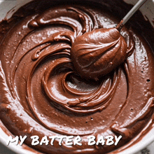 a bowl of chocolate frosting with the words my batter baby below