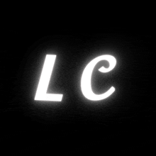 a white letter lc is glowing in the dark