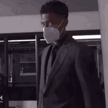 a man in a suit and tie is wearing a mask