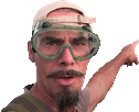 a man with a beard wearing a hat and goggles is pointing at something .