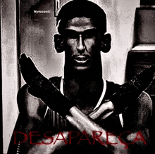 a black and white photo of a man holding a knife with the word desaparecida in red letters