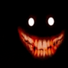 a close up of a scary smiley face with glowing eyes in the dark