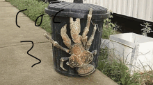 a garbage can with a crab in it is on the sidewalk .