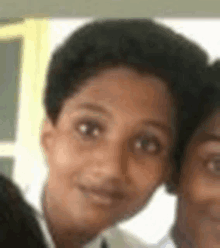 a close up of a young boy 's face with a blurry background .