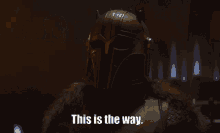 a man in a helmet says " this is the way " in a dark room