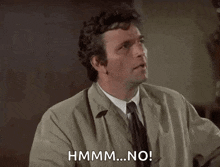 a man in a trench coat and tie is making a funny face and saying `` no '' .