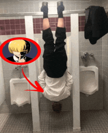 a man hanging upside down in a public restroom next to urinals