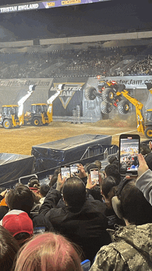 a crowd of people watching a monster jam event