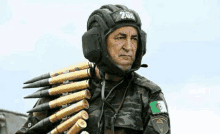 a man in a helmet is carrying a bunch of bullets .