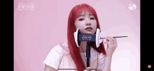 a girl with red hair is wearing a pair of ear buds with the word mnet on it