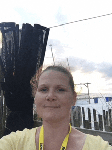 a woman wearing a yellow lanyard with the word resort on it smiles