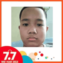 a picture of a young boy 's face with a 7.7 mid year sale advertisement in the background