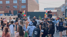 a large crowd of people are gathered in front of a building with a sign that says brewing co.