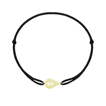 a black string bracelet with a small gold arrow shaped pendant